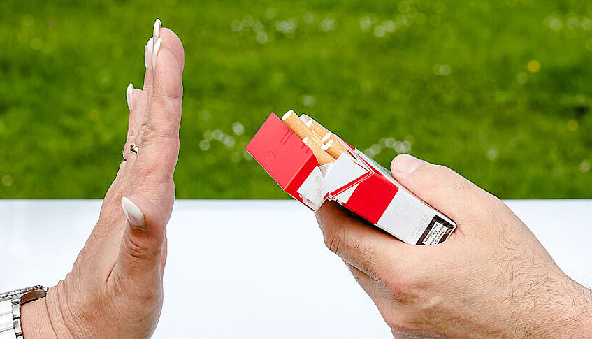 female hand is declining the offer for cigarettes