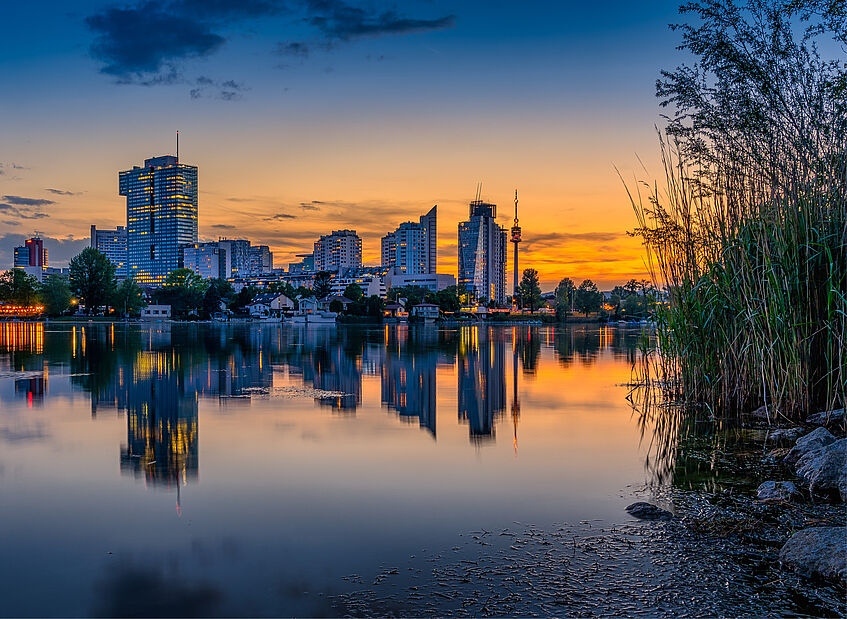 Danube in Vienna with sunset over the city. 