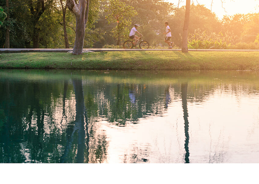 peaceful lake with water reflections and a man biking along
</p>
<p>